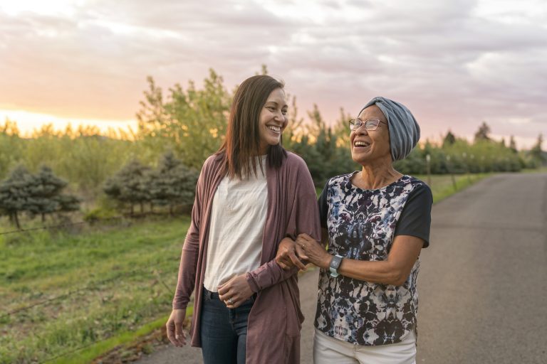 Beautiful mixed race mother and daughter relaxing outdoors together